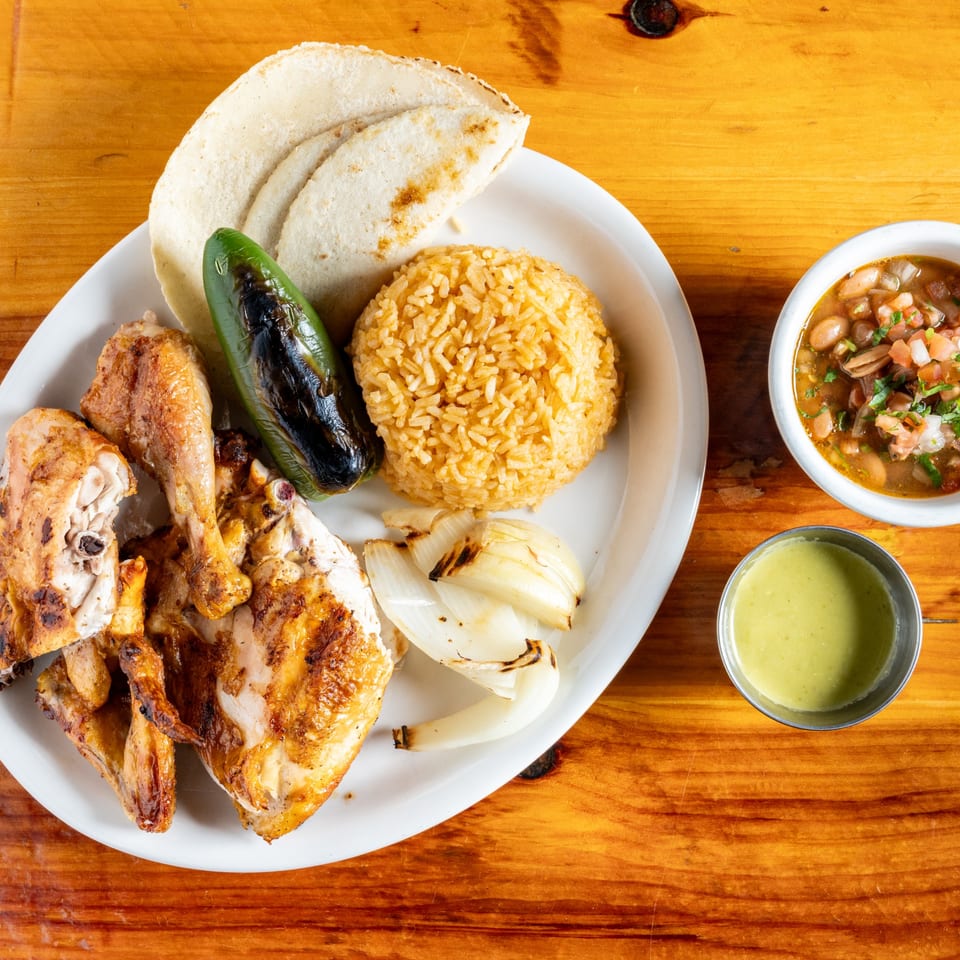 El Rey Del Grill's grilled chicken with rice, tortillas, charred jalapeno, onions, beans, and green sauce.
