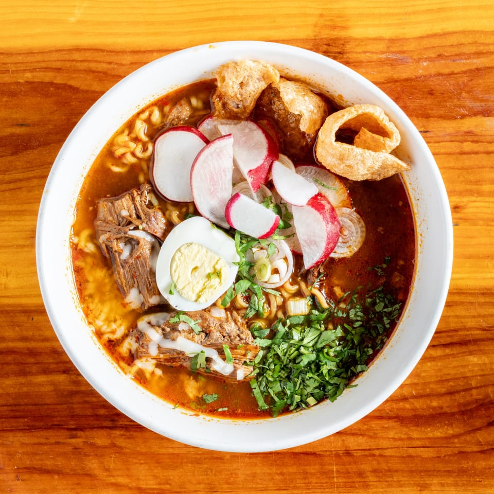 El Rey Del Grill's Mexican soup with meat, noodles, radishes, egg, cilantro, and chicharrones.